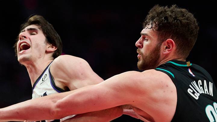 Apr 12, 2026: Sacramento Kings center Maxime Raynaud is fouled by Portland Trail Blazers center Donovan Clingan during the second half as he drives to the hoop at Moda Center. Mandatory Credit: Troy Wayrynen