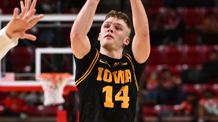 Feb 11, 2026; College Park, Maryland, USA;  Iowa Hawkeyes guard Bennett Stirtz (#14) shoots for three points in the first half against the Maryland Terrapins at Xfinity Center. Mandatory Credit: Jamie Sabau-Imagn Images
