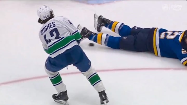 Vancouver Canucks D Quinn Hughes assists on a Conor Garland goal against the St. Louis Blues. Vancouver Canucks D Quinn Hughes assists on a Conor Garland goal against the St. Louis Blues.