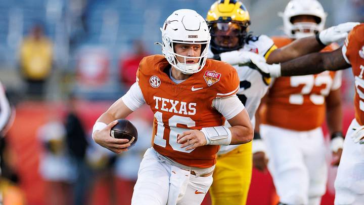 Texas Longhorns quarterback Arch Manning runs with the ball against the Michigan Wolverines Texas Longhorns quarterback Arch Manning runs with the ball against the Michigan Wolverines