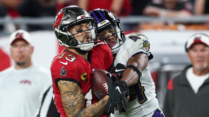 Oct 27, 2022; Tampa, Florida, USA;  Tampa Bay Buccaneers wide receiver Mike Evans (13) catches a pass defended by Baltimore Ravens cornerback Marlon Humphrey (44) in the fourth quarter at Raymond James Stadium. Mandatory Credit: Nathan Ray Seebeck-Imagn Images