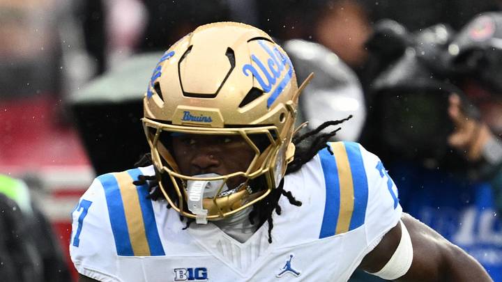 Sep 26, 2026; College Park, Maryland, USA;  UCLA Bruins defensive back Ta'Shawn James (27) gets past Maryland Terrapins quarterback Malik Washington (7) to return an interception for a touchdown in the second half at SECU Stadium. Mandatory Credit: Jamie Sabau-Imagn Images