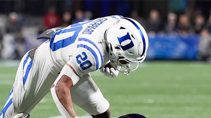 Dec 6, 2025; Charlotte, NC, USA; Duke Blue Devils running back Nate Sheppard (20) is brought down by safety Devin Neal (27) and defensive back Donavon Platt (28) during the second half during the 2025 ACC Championship game at Bank of America Stadium. Mandatory Credit: Jim Dedmon-Imagn Images Dec 6, 2025; Charlotte, NC, USA; Duke Blue Devils running back Nate Sheppard (20) is brought down by safety Devin Neal (27) and defensive back Donavon Platt (28) during the second half during the 2025 ACC Championship game at Bank of America Stadium. Mandatory Credit: Jim Dedmon-Imagn Images