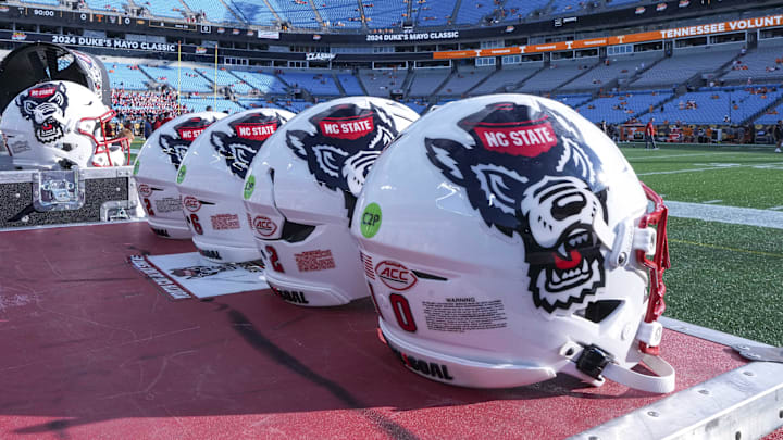 Sep 7, 2024; Charlotte, North Carolina, USA; North Carolina State Wolfpack helmets during pregame activity for the Dukes Mayo Classic against the Tennessee Volunteers at Bank of America Stadium. Mandatory Credit: Jim Dedmon-Imagn Images