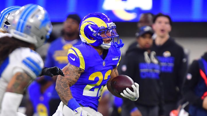 Dec 14, 2025; Inglewood, California, USA; Los Angeles Rams running back Blake Corum (22) runs the ball past Detroit Lions cornerback Rock Ya-Sin (23) during the fourth quarter at SoFi Stadium. Mandatory Credit: Gary A. Vasquez-Imagn Images