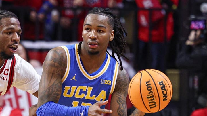 Jan 13, 2025; Piscataway, New Jersey, USA; UCLA Bruins guard Sebastian Mack (12) looks to pass as Rutgers Scarlet Knights guard Jeremiah Williams (25) defends during the second half at Jersey Mike's Arena. Mandatory Credit: Vincent Carchietta-Imagn Images