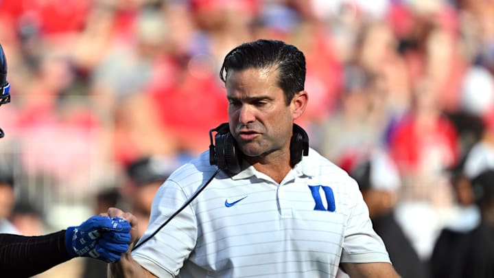 Sep 20, 2025; Durham, North Carolina, USA;  Duke Blue Devils head coach Manny Diaz interacts with safety Ma'khi Jones (26) during the first quarter against the NC State Wolfpack at Wallace Wade Stadium. Mandatory Credit: Zachary Taft-Imagn Images