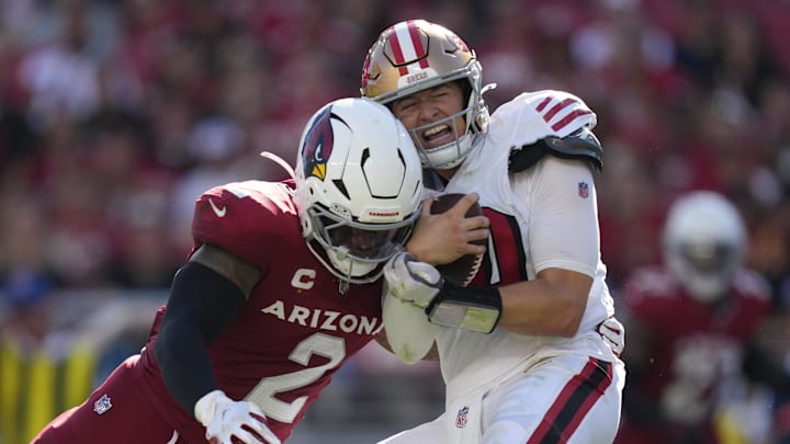Sep 21, 2025; Santa Clara, California, USA; San Francisco 49ers quarterback Mac Jones (10) is tackled by Arizona Cardinals linebacker Mack Wilson (2) during the second half at Levi's Stadium. Mandatory Credit: Kyle Terada-Imagn Images
