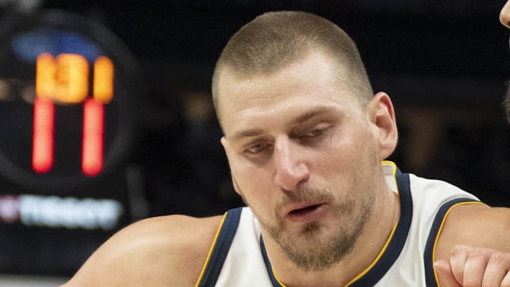 Apr 30, 2026; Minneapolis, Minnesota, USA; Denver Nuggets center Nikola Jokic (15) dribbles the ball as Minnesota Timberwolves center Rudy Gobert (27) played defense in the second half during game six of the first round of the 2026 NBA Playoffs at Target Center. Mandatory Credit: Jesse Johnson-Imagn Images