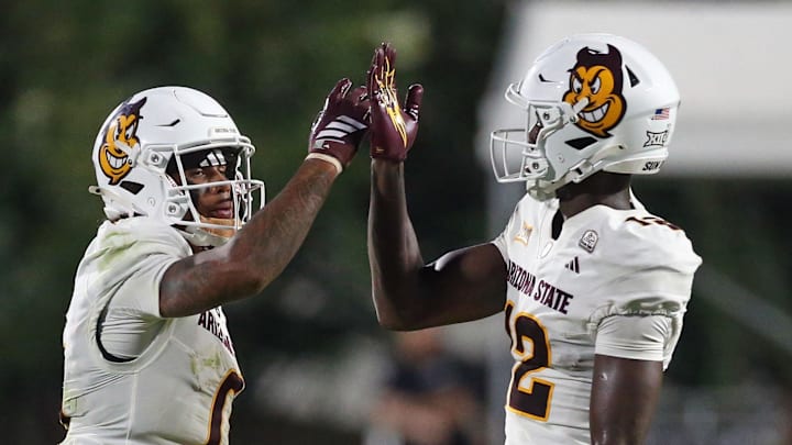 Sep 6, 2025; Starkville, Mississippi, USA; Arizona State Sun Devils wide receiver Jordyn Tyson (0) and wide receiver Malik McClain (12) react after a catch during the fourth quarter against the Mississippi State Bulldogs at Davis Wade Stadium at Scott Field. Mandatory Credit: Petre Thomas-Imagn Images