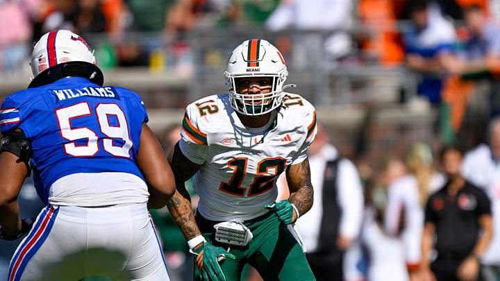 Nov 1, 2025; Dallas, Texas, USA; SMU Mustangs offensive lineman PJ Williams (59) blocks Miami Hurricanes defensive lineman Marquise Lightfoot (12) during the game between the Mustangs and the Hurricanes at Gerald J. Ford Stadium. Mandatory Credit: Jerome Miron-Imagn Images Nov 1, 2025; Dallas, Texas, USA; SMU Mustangs offensive lineman PJ Williams (59) blocks Miami Hurricanes defensive lineman Marquise Lightfoot (12) during the game between the Mustangs and the Hurricanes at Gerald J. Ford Stadium. Mandatory Credit: Jerome Miron-Imagn Images
