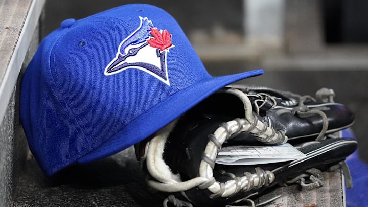 Apr 16, 2025; Toronto, Ontario, CAN; A Toronto Blue Jays hat and glove in the dugout during a game against the Atlanta Braves at Rogers Centre. Apr 16, 2025; Toronto, Ontario, CAN; A Toronto Blue Jays hat and glove in the dugout during a game against the Atlanta Braves at Rogers Centre.