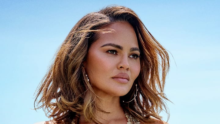 Chrissy Teigen was photographed by Yu Tsai in Los Angeles. Swimsuit by Natalia Fedner. Earrings by Jacquie Aiche. 