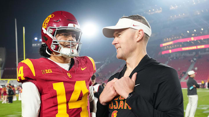 Nov 29, 2025; Los Angeles, California, USA; Southern California Trojans quarterback Jayden Maiava (14) and head coach Lincoln Riley react after the game against the UCLA Bruins at United Airlines Field at Los Angeles Memorial Coliseum. Mandatory Credit: Kirby Lee-Imagn Images
