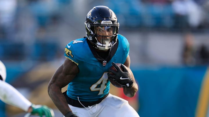 Jacksonville Jaguars running back Tank Bigsby (4) rushes for yards against New York Jets cornerback Kendall Sheffield (27) during the fourth quarter Sunday, Dec. 15, 2024 at EverBank Stadium in Jacksonville, Fla. The Jets held off the Jaguars 32-25. [Corey Perrine/Florida Times-Union]