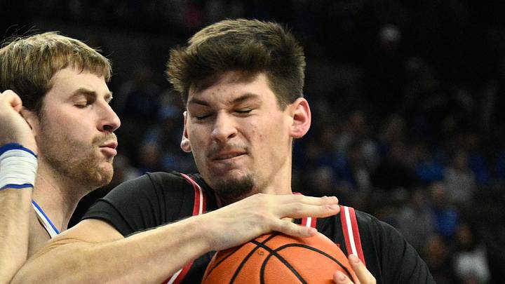 Nov 5, 2025; Omaha, Nebraska, USA;  South Dakota Coyotes center Cameron Fens (54) drives against Creighton Bluejays forward Isaac Traudt (41) during the first half at CHI Health Center Omaha. Mandatory Credit: Steven Branscombe-Imagn Images