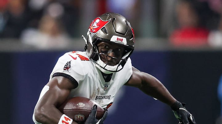 Oct 3, 2024; Atlanta, Georgia, USA; Tampa Bay Buccaneers wide receiver Chris Godwin (14) is pursued by Atlanta Falcons safety Justin Simmons (31) in the first quarter at Mercedes-Benz Stadium. Mandatory Credit: Brett Davis-Imagn Images