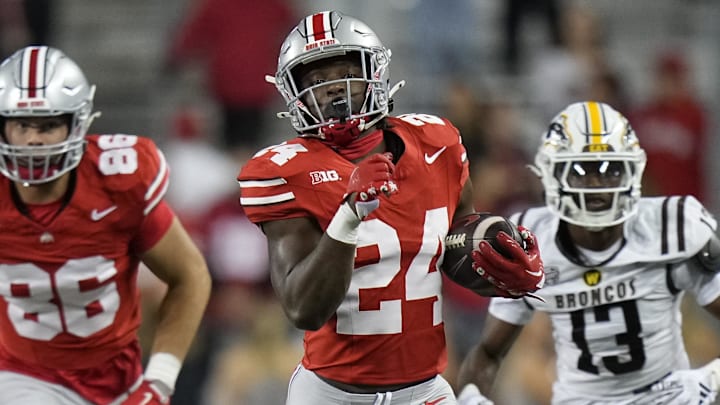 Sep 7, 2024; Columbus, Ohio, USA;  Ohio State Buckeyes running back Sam Williams-Dixon (24) runs upfield past Western Michigan Broncos cornerback Lorenzo Williams Jr. (14) during the second half at Ohio Stadium.  Mandatory Credit: Adam Cairns-Imagn Images