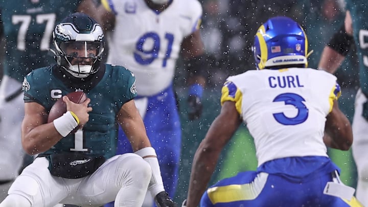 Jan 19, 2025; Philadelphia, Pennsylvania, USA; Philadelphia Eagles quarterback Jalen Hurts (1) carries the ball as Los Angeles Rams safety Kamren Curl (3) defends in the second quarter in a 2025 NFC divisional round game at Lincoln Financial Field. Mandatory Credit: Bill Streicher-Imagn Images