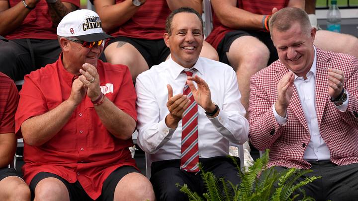 University of Oklahoma baseball coach Skip Johnson, left, president Joseph Harroz Jr., and athletic director Roger Denny smile as they sit on stage as Oklahoma Sooners celebrate their NCAA baseball College World Series championship in a ceremony at Kimrey Family Stadium.