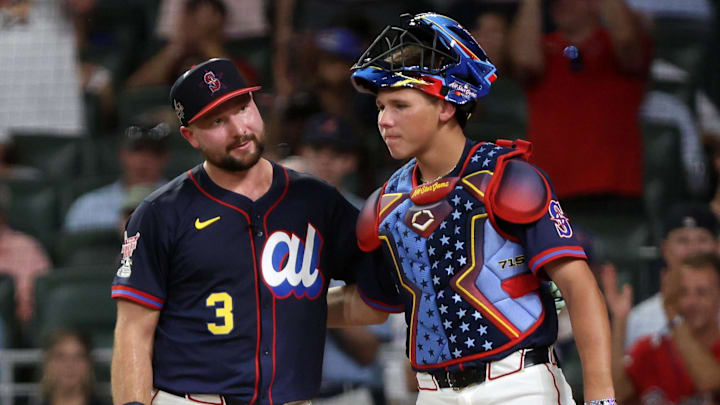 Seattle Mariners catcher Cal Raleigh reacts to winning the Home Run Derby alongside his brother Todd Jr.