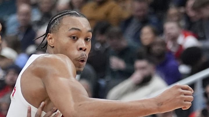 Toronto Raptors guard Scottie Barnes tries to dribble around Detroit Pistons forward Ausar Thompson.