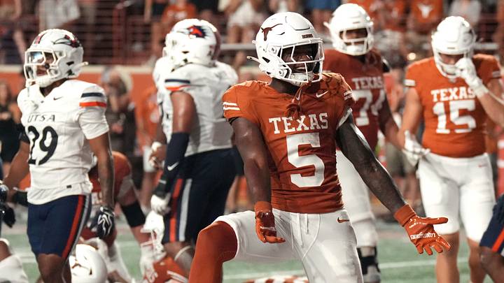Texas Longhorns running back Derrek Cooper (5) reacts ahead of quarterback Arch Manning (16) after running for his first collegiate touchdown during the second half against the UTSA Roadrunners at Darrell K Royal-Texas Memorial Stadium. Texas Longhorns running back Derrek Cooper (5) reacts ahead of quarterback Arch Manning (16) after running for his first collegiate touchdown during the second half against the UTSA Roadrunners at Darrell K Royal-Texas Memorial Stadium.