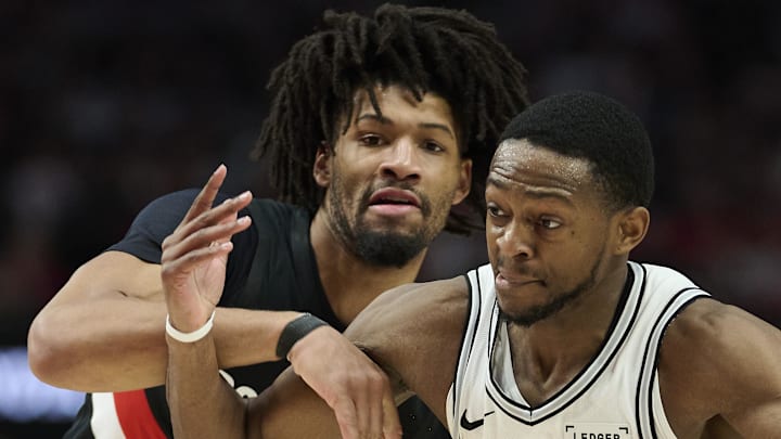 San Antonio Spurs guard De'Aaron Fox drives to the basket during the second half against Portland Trail Blazers guard Shaedon Sharpe during game four of the first round of the 2026 NBA Playoffs at Moda Center. Mandatory Credit: Troy Wayrynen-Imagn Images