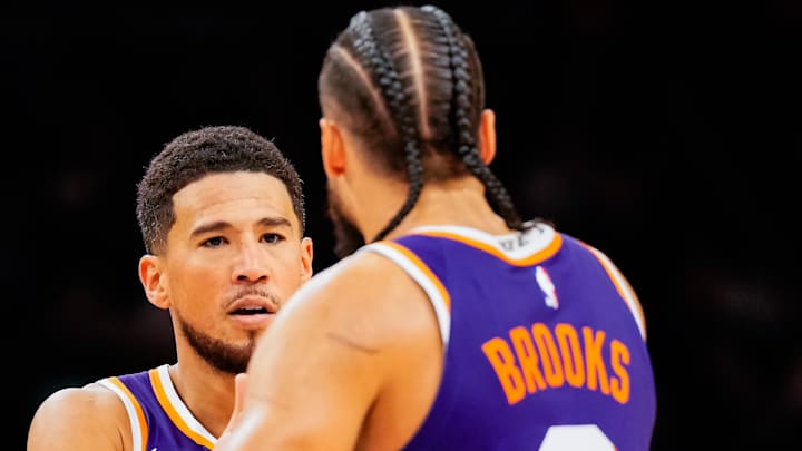 Phoenix Suns guard Devin Booker and Dillon Brooks high five in the second half of the game at Mortgage Matchup Center. Phoenix Suns guard Devin Booker and Dillon Brooks high five in the second half of the game at Mortgage Matchup Center.