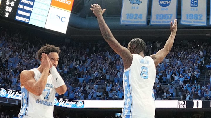 Feb 7, 2026; Chapel Hill, North Carolina, USA; North Carolina Tar Heels guard Seth Trimble (7) and forward Caleb Wilson (8) and teammates celebrate after Trimble hits a three point shot with .04 left to go in the second half at Dean E. Smith Center. Mandatory Credit: Bob Donnan-Imagn Images