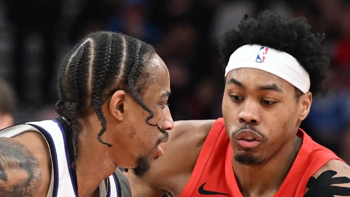 Sacramento Kings forward DeMar DeRozan controls the ball against Toronto Raptors forward Scottie Barnes.