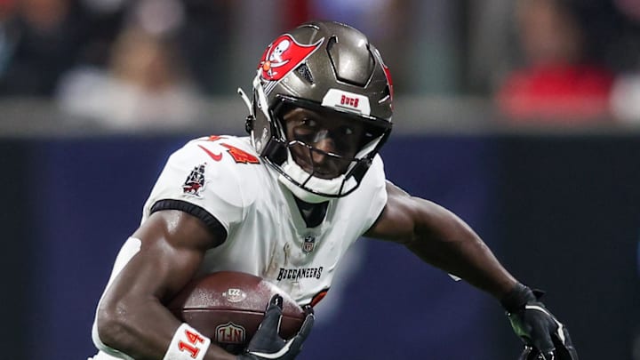 Oct 3, 2024; Atlanta, Georgia, USA; Tampa Bay Buccaneers wide receiver Chris Godwin (14) is pursued by Atlanta Falcons safety Justin Simmons (31) in the first quarter at Mercedes-Benz Stadium. Mandatory Credit: Brett Davis-Imagn Images