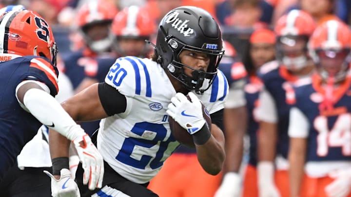 Sep 27, 2025; Syracuse, New York, USA; Duke Blue Devils running back Nate Sheppard (20) tries to run past Syracuse Orange defensive back Braheem Long Jr. (0) in the third quarter at the JMA Wireless Dome. Mandatory Credit: Mark Konezny-Imagn Images Sep 27, 2025; Syracuse, New York, USA; Duke Blue Devils running back Nate Sheppard (20) tries to run past Syracuse Orange defensive back Braheem Long Jr. (0) in the third quarter at the JMA Wireless Dome. Mandatory Credit: Mark Konezny-Imagn Images