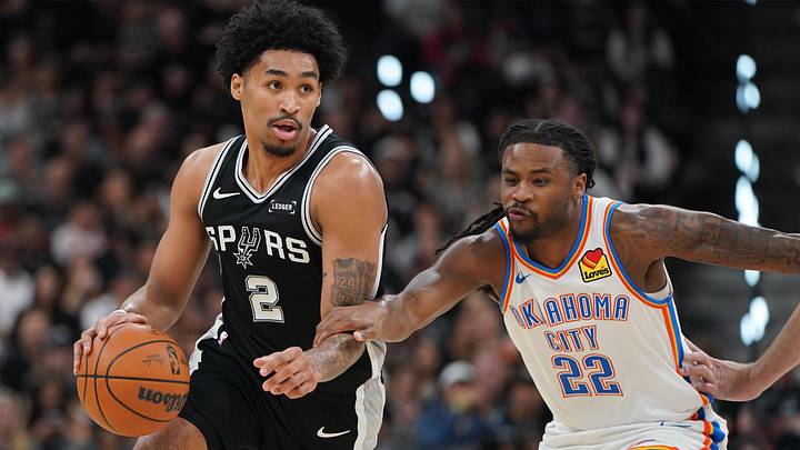 May 28, 2026; San Antonio, Texas, USA; San Antonio Spurs guard Dylan Harper (2) dribbles the ball past Oklahoma City Thunder guard Cason Wallace (22) in the first half during Game 6 of the Western Conference Finals for the 2026 NBA Playoffs at Frost Bank Center.