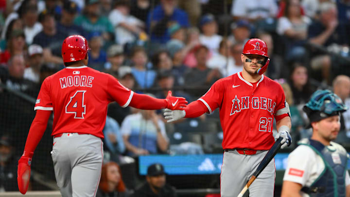 Sep 13, 2025; Seattle, Washington, USA; Los Angeles Angels second baseman Christian Moore (4) and designated hitter Mike Trout (27) celebrate after Moore scored a run against the Seattle Mariners during the second inning at T-Mobile Park. Mandatory Credit: Steven Bisig-Imagn Images Sep 13, 2025; Seattle, Washington, USA; Los Angeles Angels second baseman Christian Moore (4) and designated hitter Mike Trout (27) celebrate after Moore scored a run against the Seattle Mariners during the second inning at T-Mobile Park. Mandatory Credit: Steven Bisig-Imagn Images
