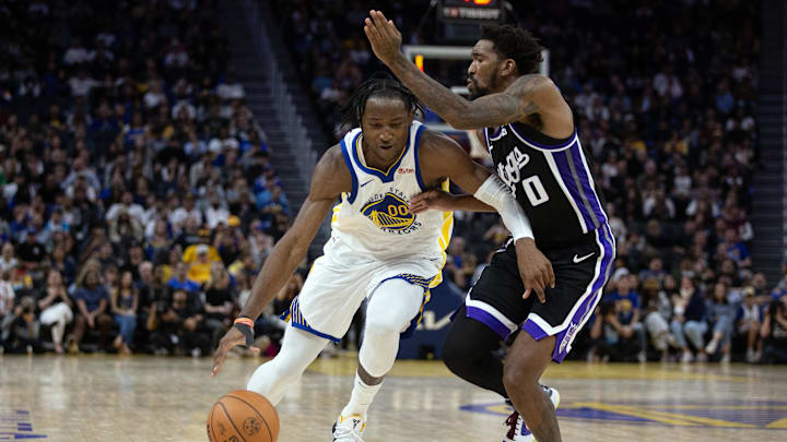 Oct 18, 2023; San Francisco, California, USA; Golden State Warriors forward Jonathan Kuminga (00) drives past Sacramento Kings guard Malik Monk (0) during the fourth quarter at Chase Center. Mandatory Credit: D. Ross Cameron-Imagn Images Oct 18, 2023; San Francisco, California, USA; Golden State Warriors forward Jonathan Kuminga (00) drives past Sacramento Kings guard Malik Monk (0) during the fourth quarter at Chase Center. Mandatory Credit: D. Ross Cameron-Imagn Images