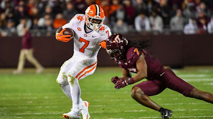 Nov 9, 2024; Blacksburg, Virginia, USA;  Virginia Tech Hokies linebacker Keonta Jenkins (7) dives to tackle Clemson Tigers running back Phil Mafah (7) during the fourth quarter at Lane Stadium.