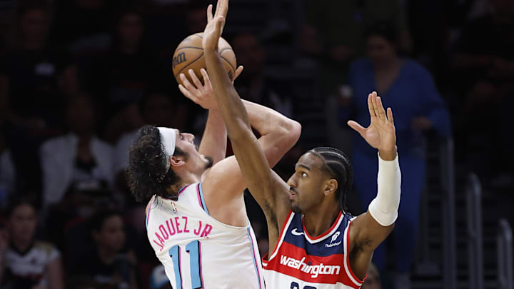Apr 13, 2025; Miami, Florida, USA;  Washington Wizards forward Alex Sarr (20) defends Miami Heat guard Jaime Jaquez Jr. (11) during the second half at Kaseya Center. Mandatory Credit: Rhona Wise-Imagn Images