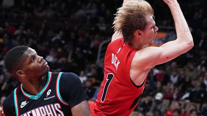 Nov 2, 2025; Toronto, Ontario, CAN; Toronto Raptors guard Gradey Dick (1) drives to the basket over Memphis Grizzlies forward Cedric Coward (23) during the fourth quarter at Scotiabank Arena. Mandatory Credit: Nick Turchiaro-Imagn Images