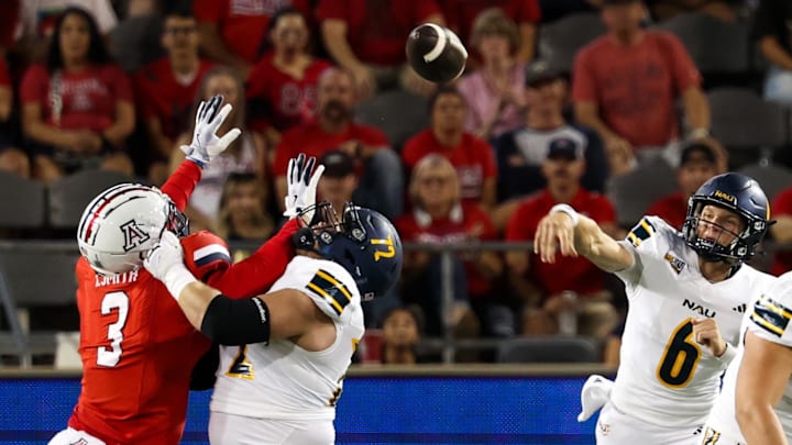 Sep 7, 2024; Tucson, Arizona, USA; Arizona Lumberjacks quarterback Ty Pennington (6) throws the ball against Arizona Wildcats defensive lineman Tre Smith (3) during first quarter at Arizona Stadium. Sep 7, 2024; Tucson, Arizona, USA; Arizona Lumberjacks quarterback Ty Pennington (6) throws the ball against Arizona Wildcats defensive lineman Tre Smith (3) during first quarter at Arizona Stadium.
