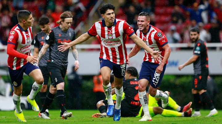 Guadalajara's Erick Gutiérrez celebrates after scoring as Ronaldo Cisneros (left) races in to join him.