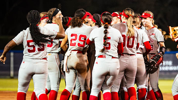 Nebraska softball players celebrate after beating No. 6 Tennessee to open the 2025 season.