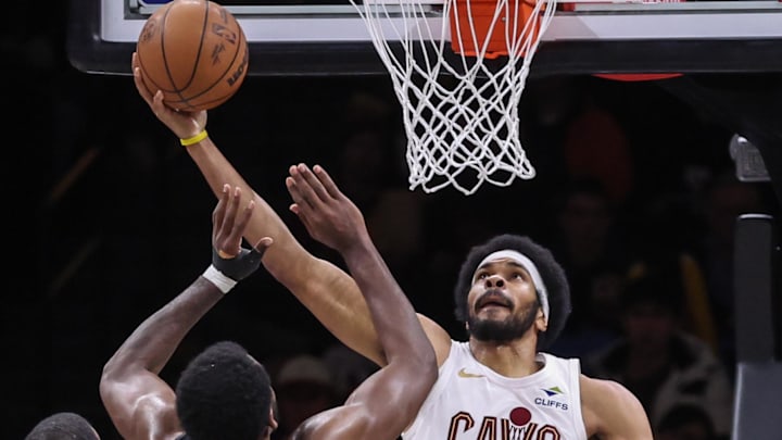 Mar 1, 2026; Brooklyn, New York, USA;  Cleveland Cavaliers center Jarrett Allen (31) puts up a reverse layup past Brooklyn Nets center Day'ron Sharpe (20) in the third quarter at Barclays Center. Mandatory Credit: Wendell Cruz-Imagn Images
