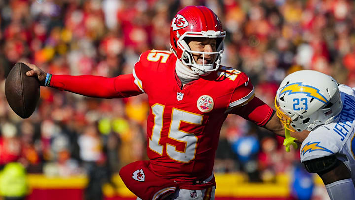 Dec 14, 2025; Kansas City, Missouri, USA; Kansas City Chiefs quarterback Patrick Mahomes (15) scrambles against Los Angeles Chargers safety Tony Jefferson (23) during the first half at GEHA Field at Arrowhead Stadium. Mandatory Credit: Jay Biggerstaff-Imagn Images