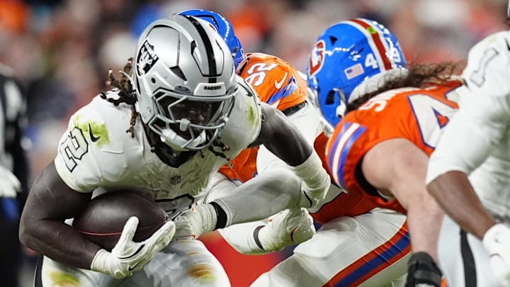 Nov 6, 2025; Denver, Colorado, USA; Las Vegas Raiders running back Ashton Jeanty (2) rushes the ball against the Denver Broncos during the second half at Empower Field at Mile High. Mandatory Credit: Ron Chenoy-Imagn Images