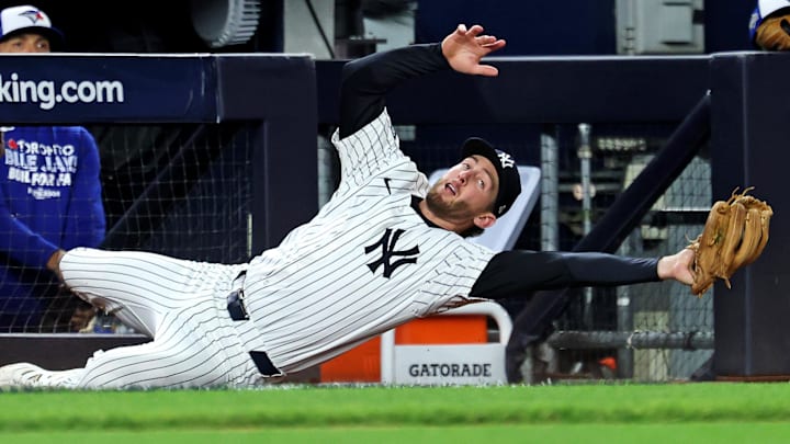 Oct 8, 2025; Bronx, New York, USA; New York Yankees third baseman Ryan McMahon (19) makes a catch during the seventh inning against the Toronto Blue Jays during game four of the ALDS round for the 2025 MLB playoffs at Yankee Stadium. Mandatory Credit: Vincent Carchietta-Imagn Images