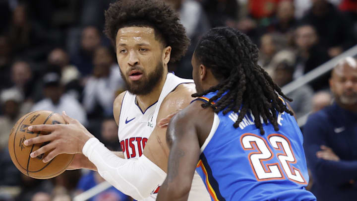 Feb 25, 2026; Detroit, Michigan, USA;  Detroit Pistons guard Cade Cunningham (2) is defended by Oklahoma City Thunder guard Cason Wallace (22) in the first half at Little Caesars Arena.