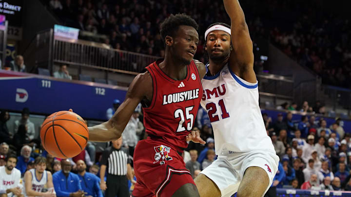 Jan 21, 2025; Dallas, Texas, USA; Louisville Cardinals forward Aboubacar Traore (25) looks to pass the ball as SMU Mustangs forward Yohan Traore (21) applies the defensive pressure during the first half at Moody Coliseum. 