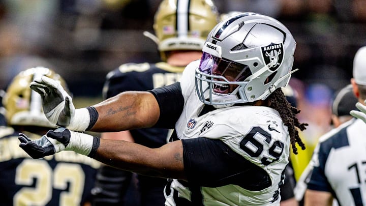 Dec 29, 2024; New Orleans, Louisiana, USA;  Las Vegas Raiders defensive tackle Adam Butler (69) reacts to making a third down stop against New Orleans Saints quarterback Spencer Rattler (18) during the second half at Caesars Superdome. Mandatory Credit: Stephen Lew-Imagn Images