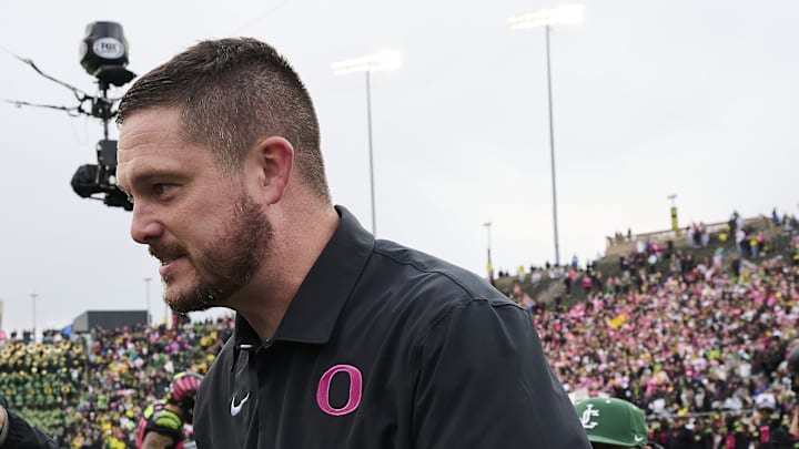 Oct 22, 2022; Eugene, Oregon, USA; UCLA Bruins head coach Chip Kelly, left, congratulates Oregon Ducks head coach Dan Lanning after a game at Autzen Stadium. The Ducks won the game 45-30. Mandatory Credit: Troy Wayrynen-Imagn Images